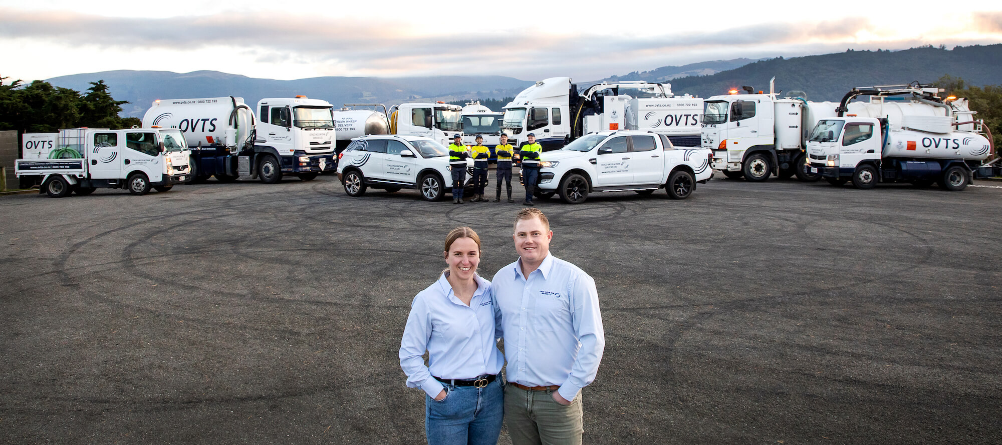 tim and courtney standing in front of the fleet